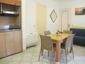 a kitchen and dining room with a wooden table and chairs at Aparthotel Villa Marinù in Ischia