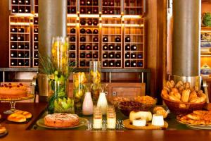 a table with many different types of bread and pastries at Casa Melo Alvim - by Unlock Hotels in Viana do Castelo