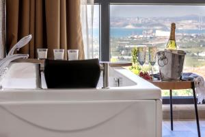 a kitchen with a white sink and a window at LAGUN CASTLE HOTEL&SPA in Yalova