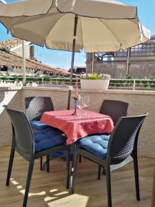 a table and chairs under an umbrella on a patio at SAN MARCO3 Apartment in Venice +14 photos