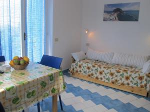 a bedroom with a bed and a table with a bowl of fruit at Aparthotel Villa Marinù in Ischia +37 photos