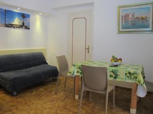 a living room with a table and a couch at Aparthotel Villa Marinù in Ischia