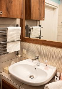 a bathroom with a white sink and a mirror at Lovely Day in Gdynia