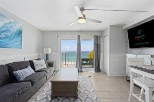 a living room with a couch and a view of the ocean at The Summit 624 in Panama City Beach