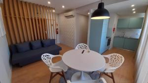 a living room with a table and chairs and a couch at Altamira EA in Estarreja