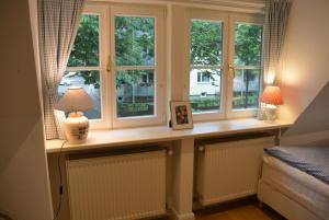 a window sill with a table with a lamp in front of it at Apartment am Park in Bremerhaven