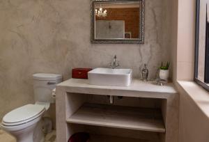 a bathroom with a sink and a toilet at Jeffreys Guest Rooms in Jeffreys Bay