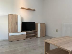 a living room with a flat screen tv on a entertainment center at Penzión u Komu Žaškov, okres Dolný Kubín in Žaškov