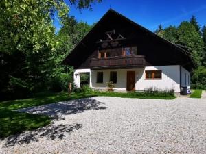 a small white house with a black roof at Haus Annaburg in Mariazell