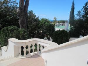 a white fence with four black chess pieces at Aparthotel Villa Marinù in Ischia
