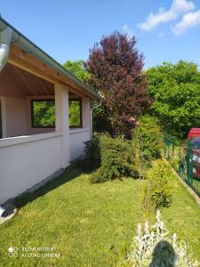 a yard with a house with a fence and trees at Vikendica Matić in Goč