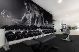 a gym with rows of dumbbells on a wall at Vitalclass Lanzarote Resort in Costa Teguise