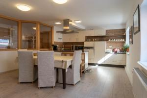 a kitchen with a dining room table and chairs at Modern Apartment in the City Center of Bad Ischl in Bad Ischl