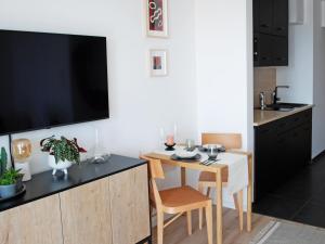 a kitchen with a small table and a television on a counter at Apartament CITY BREAK 124 in Warsaw