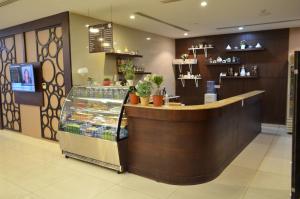 a restaurant with a counter in a store at Open Hotel Alolaya in Al Khobar