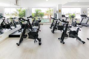 a gym with several treadmills and elliptical machines at Vitalclass Lanzarote Resort in Costa Teguise