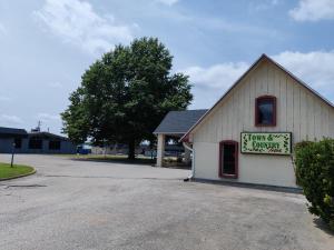 a white building with a sign on the side of it at Town and Country INN in Rogers