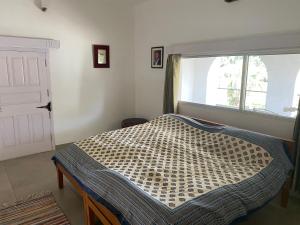 Un pat sau paturi într-o cameră la Mango Grove Farm