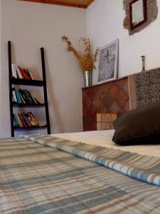 a bedroom with a large bed with a book shelf at Corral d'en Romagosa in Barcelona