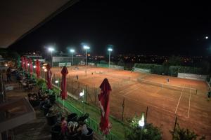 a tennis match on a tennis court at night at Evro set in Skopje
