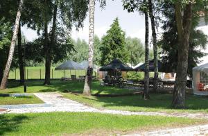 a group of picnic tables and umbrellas in a park at Spichlerz na Krakowskiej in Kazimierz Dolny