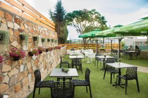 a restaurant with tables and chairs and a stone wall at Evro set in Skopje