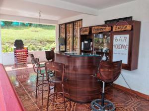 a bar with chairs and a counter in a restaurant at Finca Villa Maju in Papagalleros