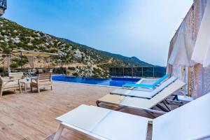 a villa with a view of a swimming pool at LA VILLA CELINE- Luxury Sea View Villa with Private Infinity Pool in Islamlar-Kalkan in Kalkan