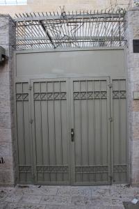 a large metal garage door in a building at Mary's House in Bethlehem