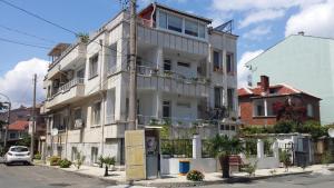 a white building on the side of a street at Guest House Margarita in Pomorie