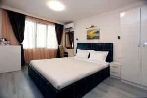 a bedroom with a large bed in a room at Deluxe 2 Studios City Center in Burgas City