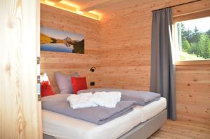 a bedroom with a bed in a log cabin at Naturchalet in San Vigilio Di Marebbe