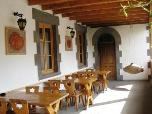a room with wooden tables and chairs in a building at Hotel Basen in Sisian