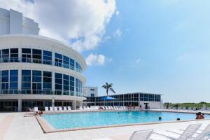 a swimming pool in front of a building at Castle Beach: Serenity Condo in Miami Beach