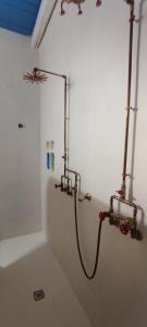 a shower in a white bathroom with a hose at Casa Mediterranea Jacuzzi riscaldata con Caminetto in Specchiolla