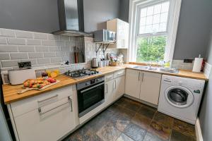 uma cozinha com um lavatório e um fogão forno superior em Cosy Urban Oasis - Quirky 2-Bed Town Centre Apartment em Bournemouth