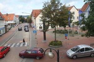 a city street with cars parked on the street at Deutsches Haus in Springe