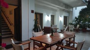a wooden table and chairs on a patio at Evripidis – Katerina Rooms –Β in Asprovalta