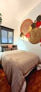 a bedroom with a bed with hats on the wall at ARGUINEGUIN, two bedrooms bungalow, pool & wifi in Arguineguín