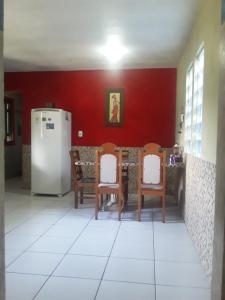 a kitchen with a table and chairs and a refrigerator at Sharing Home I in Três Coroas