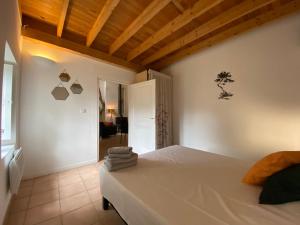 a bedroom with a white bed in a room at Orangerie de Cardet - Apartment Le Mûrier in Cardet