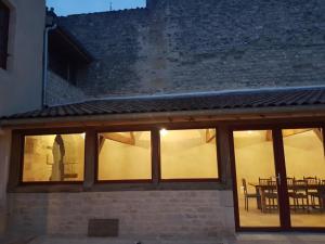 a building with glass windows with a table in the background at L'Attegia Lia in Joinville