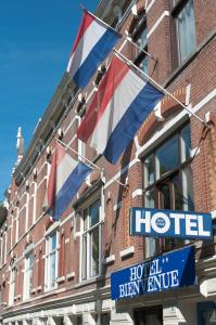 a hotel sign and a flag on the side of a building at Hotel Bienvenue in Rotterdam
