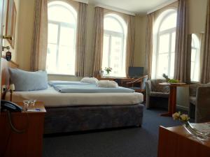 a hotel room with a bed with two towels on it at Marin Hotel Sylt in Westerland (Sylt)