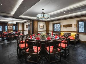 a dining room with a large table and chairs at InterContinental Resort Jiuzhai Paradise by IHG in Jiuzhaigou +182 photos
