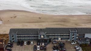 an aerial view of a building next to a beach at The Sandcastle Beachfront Hotel in Lincoln City +8 photos