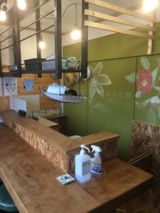 a kitchen with a counter with two bottles of soap at 47HOSTEL in Wadomari