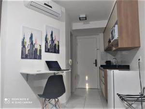 a kitchen with a desk with a laptop on it at Anhembi Expo Rodoviaria Tietê Esc Ed Fisica PM in Sao Paulo