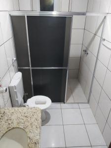 a bathroom with a shower with a toilet and a sink at Hotel Iguaçu in Dionísio Cerqueira