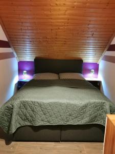 a bedroom with a large bed with two night stands at Wohnung Nähe Losheimer Stausee in Niederlosheim